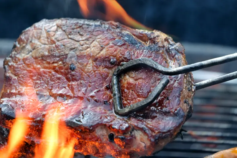 Pit Boss Grills Grilled steak meat on the grill of the grill that has a flame